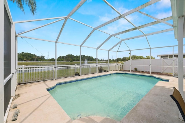 view of pool featuring a fenced in pool, a water view, and a patio area