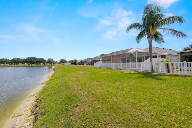 view of yard with a water view and fence