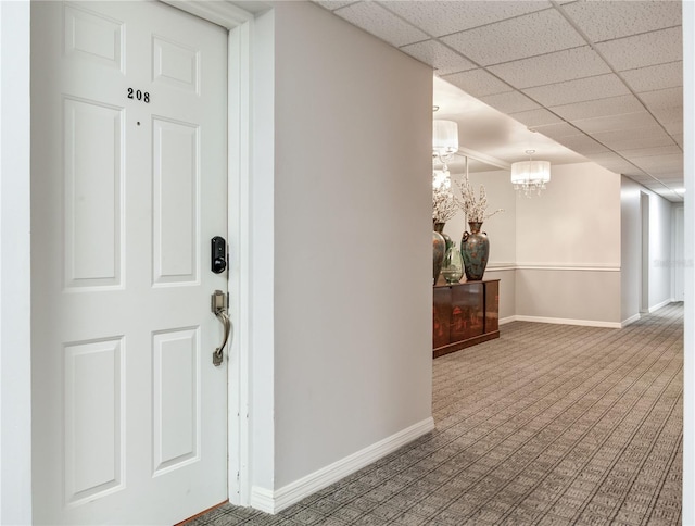 14820 Rue De Bayonne Unit 208, Clearwater, FL 33762 - entrance foyer featuring baseboards, carpet, and a notable chandelier