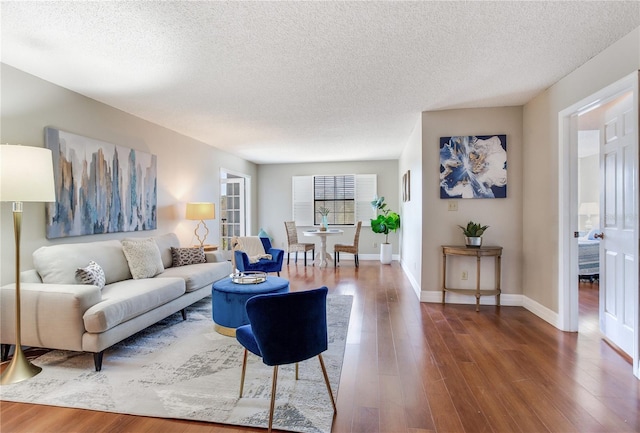 14820 Rue De Bayonne Unit 208, Clearwater, FL 33762 - living area with baseboards, a textured ceiling, and dark wood finished floors