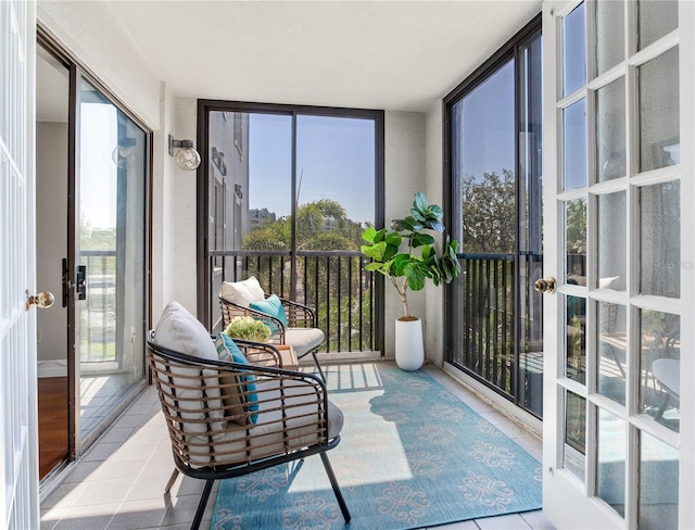 14820 Rue De Bayonne Unit 208, Clearwater, FL 33762 - sunroom / solarium featuring plenty of natural light, tile patterned flooring, and french doors