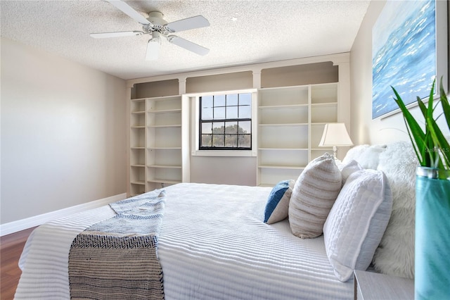 14820 Rue De Bayonne Unit 208, Clearwater, FL 33762 - bedroom featuring baseboards, a textured ceiling, ceiling fan, and wood finished floors