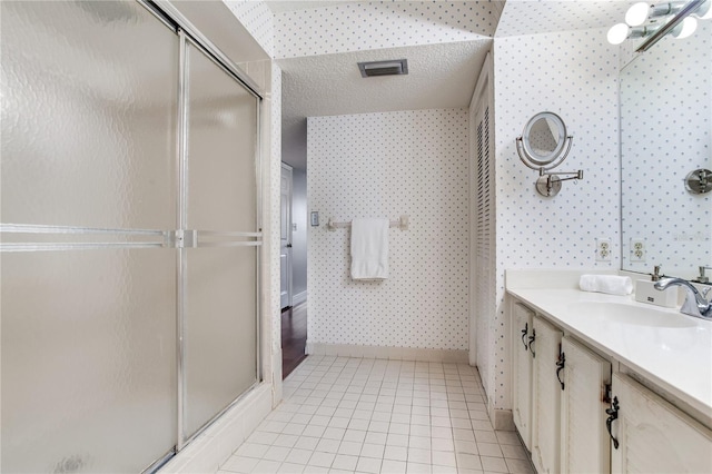14820 Rue De Bayonne Unit 208, Clearwater, FL 33762 - full bath with visible vents, vanity, a stall shower, and wallpapered walls