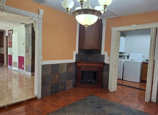 11305 SW 186th Cir, Dunnellon, FL 34432 - living area featuring gas water heater, independent washer and dryer, ornate columns, wainscoting, and a chandelier