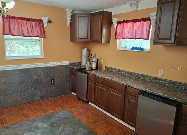 11305 SW 186th Cir, Dunnellon, FL 34432 - kitchen with dark countertops, a wainscoted wall, dishwasher, and decorative columns