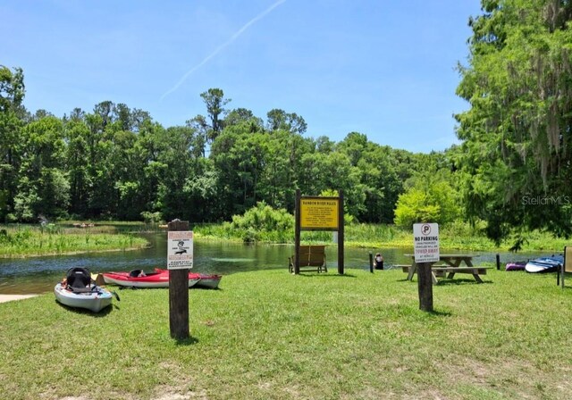 11305 SW 186th Cir, Dunnellon, FL 34432 - view of property's community with a lawn, a water view, and a view of trees