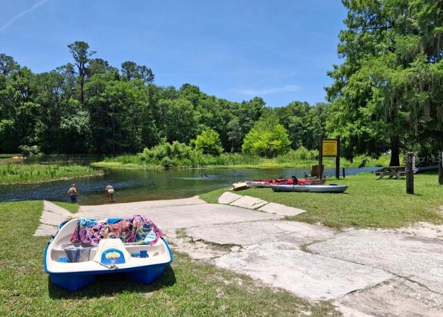 11305 SW 186th Cir, Dunnellon, FL 34432 - surrounding community featuring a water view, a lawn, and a wooded view