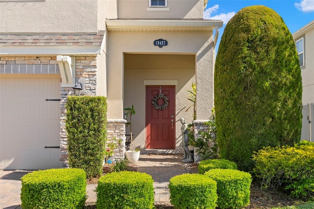 entrance to property with stucco siding and stone siding