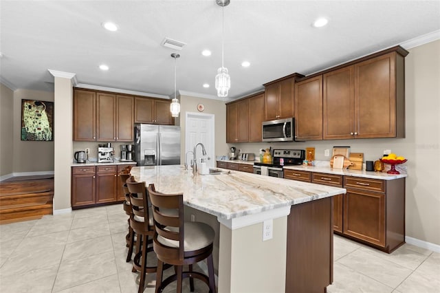 kitchen with crown molding, baseboards, light tile patterned flooring, and stainless steel appliances