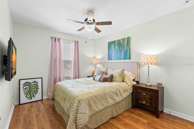 bedroom featuring baseboards, a ceiling fan, and wood finished floors