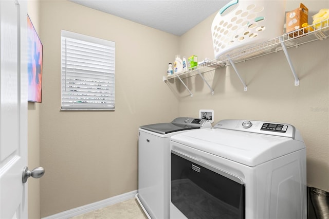 laundry area with independent washer and dryer, laundry area, and baseboards