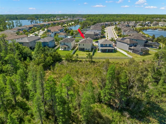 drone / aerial view featuring a water view and a residential view
