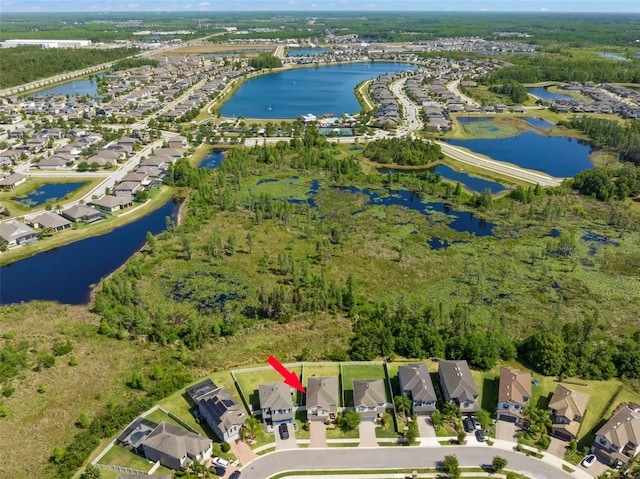 drone / aerial view featuring a residential view and a water view