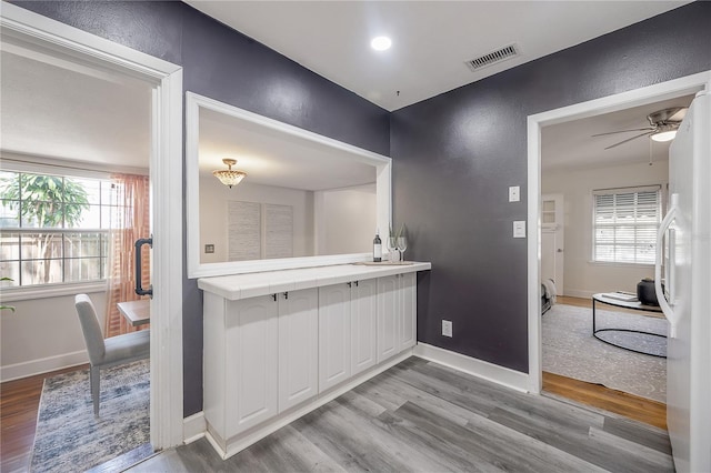 1211 E Park Cir, Tampa, FL 33604 - interior space featuring light wood-style flooring, plenty of natural light, baseboards, freestanding refrigerator, and a textured wall