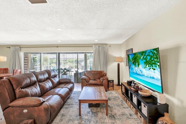 living area featuring visible vents and a textured ceiling