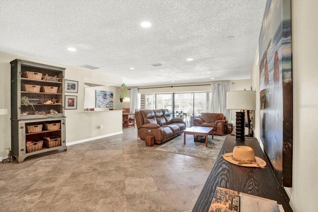 living area with recessed lighting and a textured ceiling