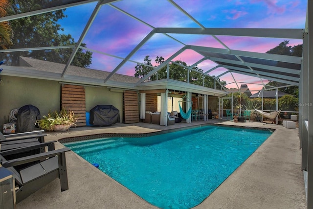 pool with a lanai and a patio