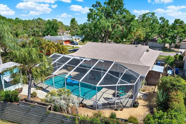 pool with glass enclosure and a patio
