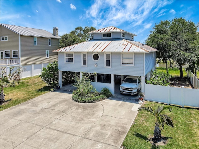 13974 75th Ave, Seminole, FL 33776 - beach home featuring a carport, concrete driveway, and metal roof