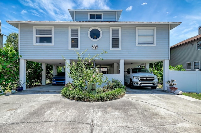 13974 75th Ave, Seminole, FL 33776 - coastal home featuring a carport, concrete driveway, and metal roof