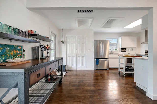 13974 75th Ave, Seminole, FL 33776 - kitchen featuring freestanding refrigerator, white cabinetry, dark wood-type flooring, and a sink