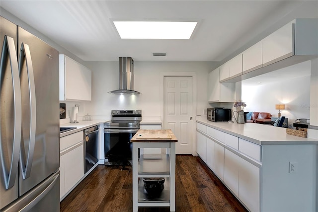 13974 75th Ave, Seminole, FL 33776 - kitchen featuring stainless steel appliances, wall chimney range hood, dark wood-style flooring, and white cabinets