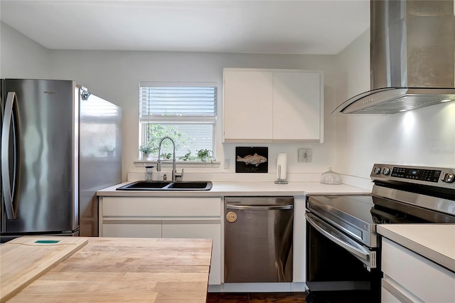 13974 75th Ave, Seminole, FL 33776 - kitchen with appliances with stainless steel finishes, wall chimney range hood, a sink, and light countertops