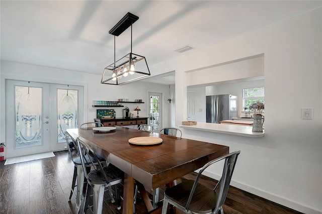 13974 75th Ave, Seminole, FL 33776 - dining space featuring plenty of natural light, dark wood-style flooring, and baseboards