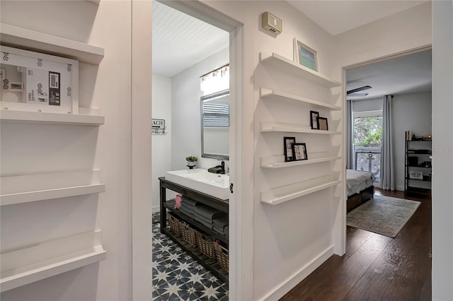 13974 75th Ave, Seminole, FL 33776 - bathroom featuring wood finished floors, connected bathroom, and vanity