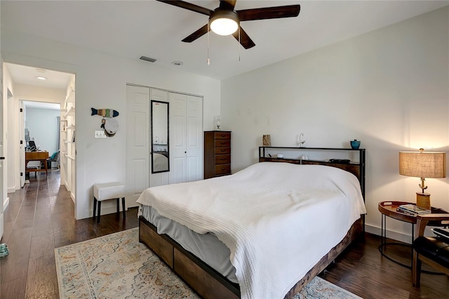 13974 75th Ave, Seminole, FL 33776 - bedroom featuring wood finished floors, a closet, baseboards, and ceiling fan