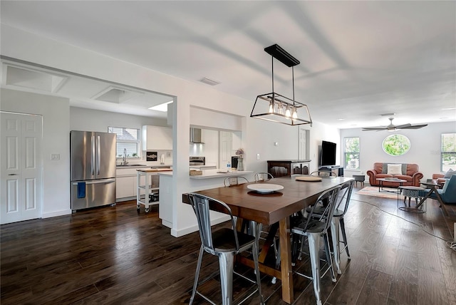 13974 75th Ave, Seminole, FL 33776 - dining space featuring dark wood-style flooring, plenty of natural light, and a ceiling fan