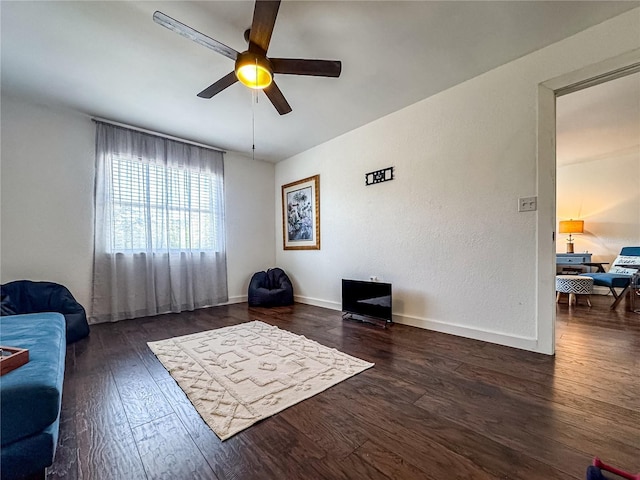 13974 75th Ave, Seminole, FL 33776 - living area with wood finished floors, ceiling fan, and baseboards