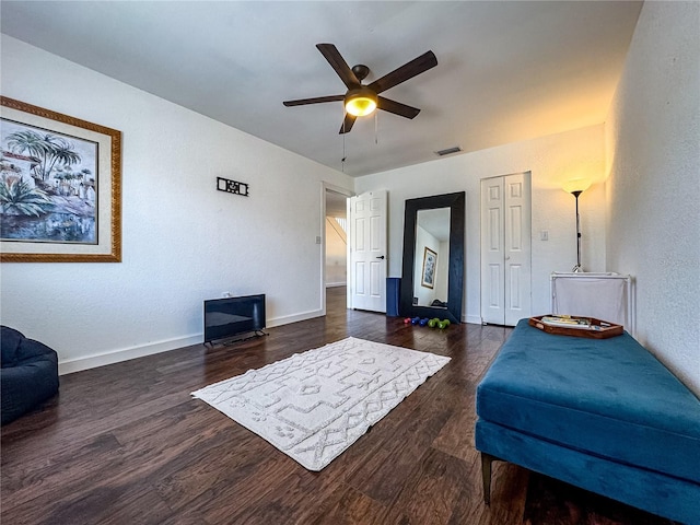 13974 75th Ave, Seminole, FL 33776 - living area with wood finished floors, ceiling fan, baseboards, and a textured wall