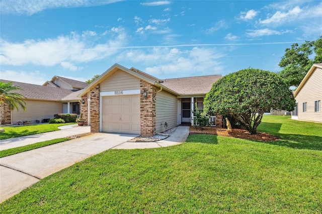 ranch-style house featuring a garage, concrete driveway, a front yard, and brick siding