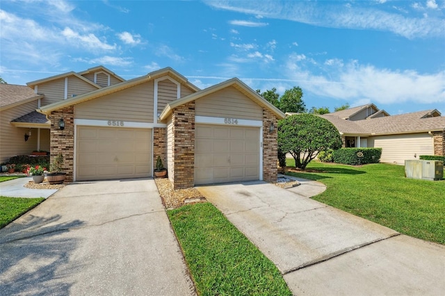 view of front of home with a front lawn, concrete driveway, a garage, and brick siding