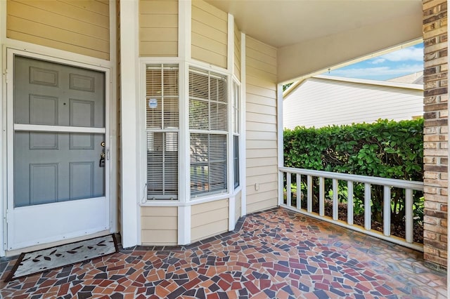 view of exterior entry with a porch
