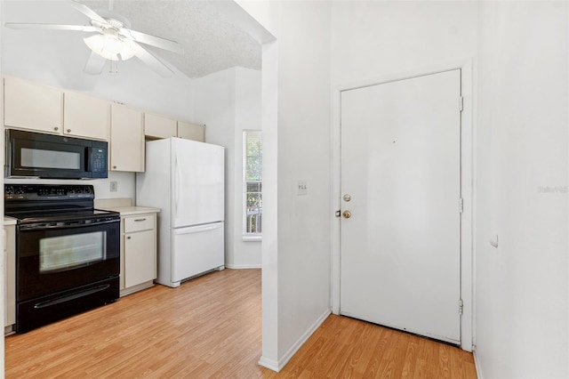 kitchen with black appliances, light wood-style flooring, light countertops, a ceiling fan, and baseboards