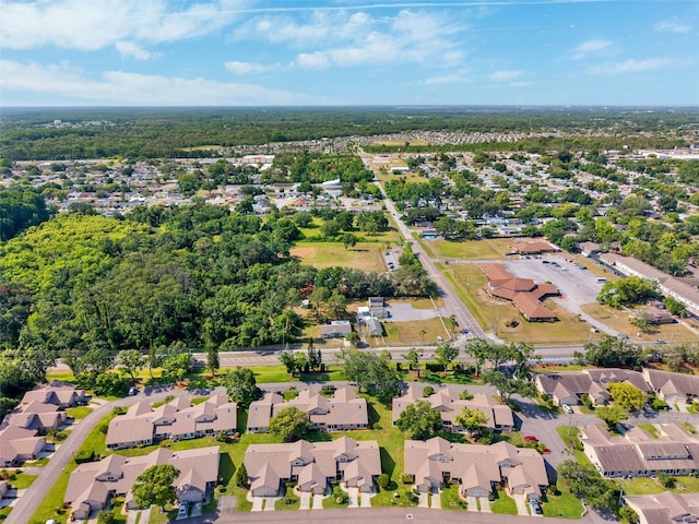 aerial view of property and surrounding area featuring nearby suburban area