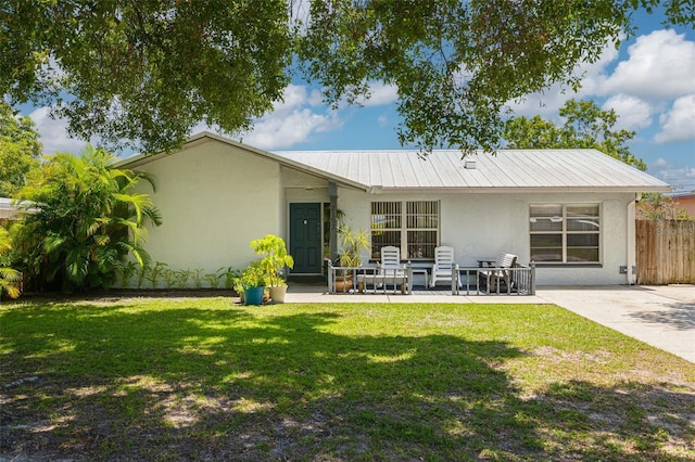 2153 Catalina Dr N, Clearwater, FL 33763 - back of house featuring stucco siding, metal roof, and a patio