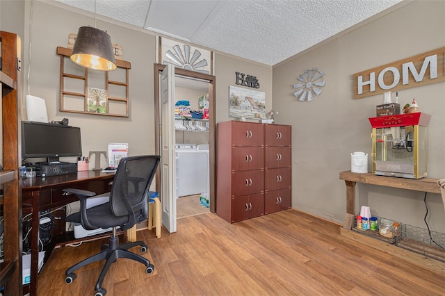 2153 Catalina Dr N, Clearwater, FL 33763 - home office with a textured ceiling, washing machine and dryer, and wood finished floors