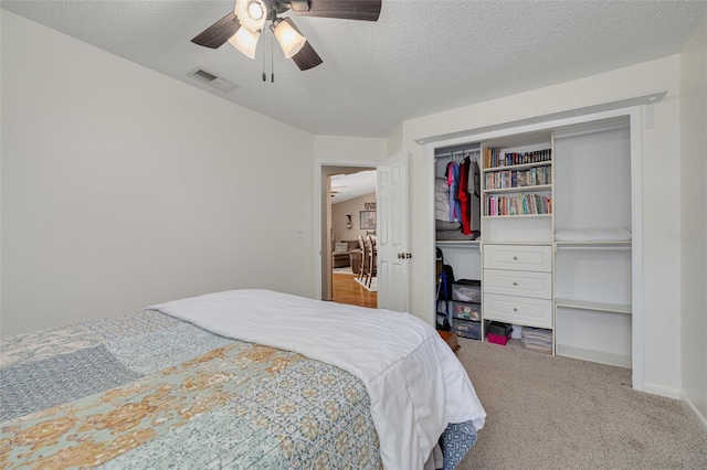 2153 Catalina Dr N, Clearwater, FL 33763 - carpeted bedroom with a textured ceiling, ceiling fan, and a closet