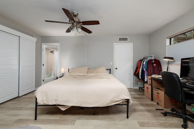 11708 Raintree Village Blvd Unit A, Temple Terrace, FL 33617 - bedroom with visible vents, a textured ceiling, light wood-style flooring, and ceiling fan