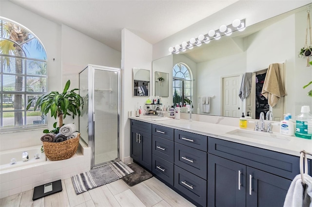 18013 Palm Breeze Dr, Tampa, FL 33647 - full bath featuring double vanity, a sink, a bath, and a stall shower