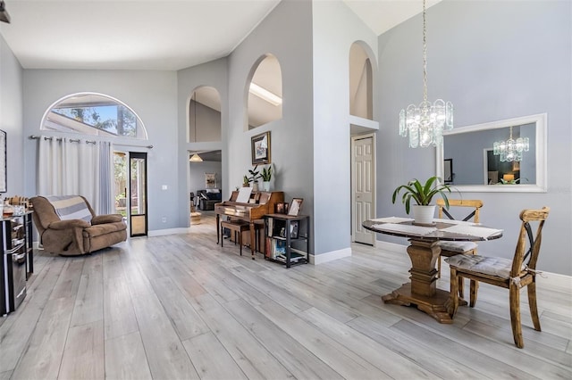 18013 Palm Breeze Dr, Tampa, FL 33647 - entrance foyer featuring baseboards, a chandelier, high vaulted ceiling, and light wood-type flooring
