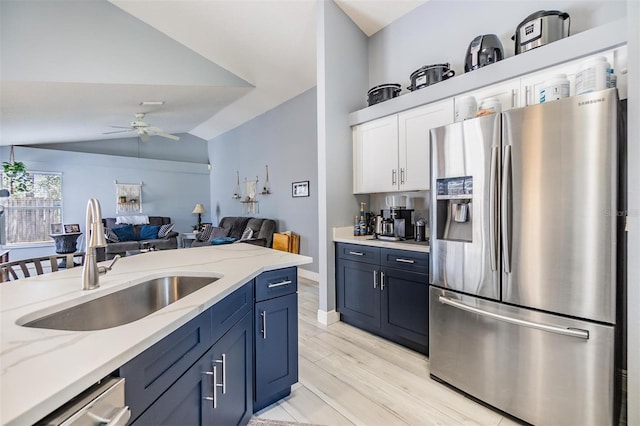 18013 Palm Breeze Dr, Tampa, FL 33647 - kitchen with a ceiling fan, appliances with stainless steel finishes, a sink, white cabinets, and lofted ceiling