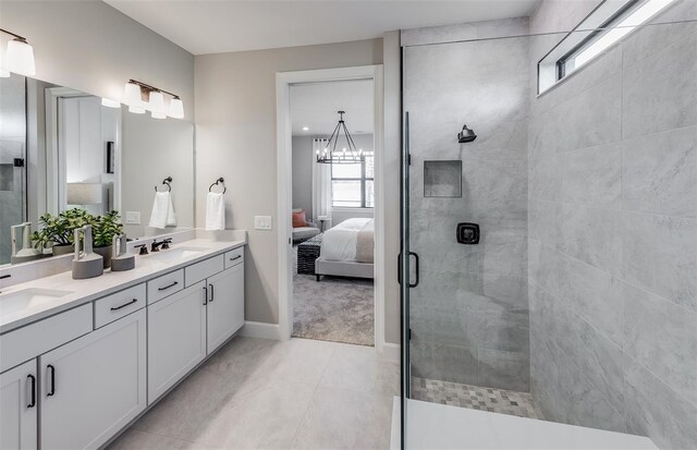 full bathroom with connected bathroom, a sink, a wealth of natural light, and tiled shower