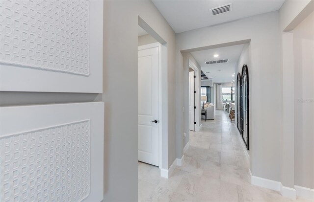 corridor featuring recessed lighting, baseboards, and visible vents