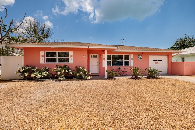 ranch-style house featuring stucco siding, a garage, fence, and concrete driveway