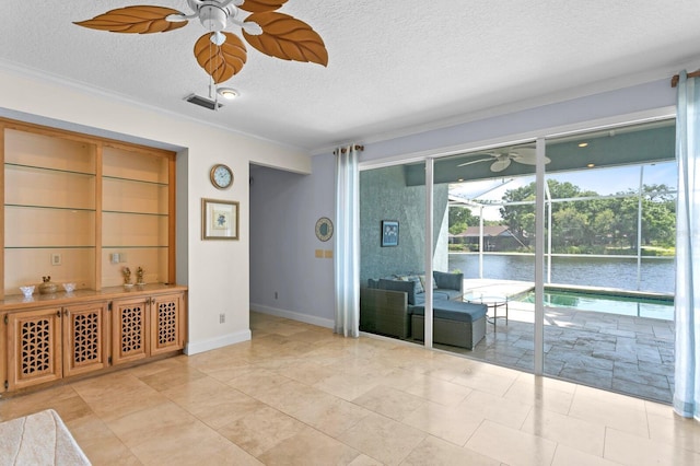 unfurnished room with visible vents, ornamental molding, a textured ceiling, and ceiling fan