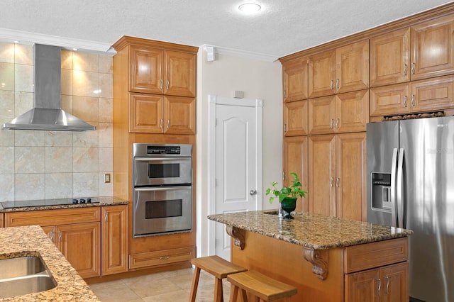 kitchen with ornamental molding, wall chimney range hood, a textured ceiling, tasteful backsplash, and appliances with stainless steel finishes